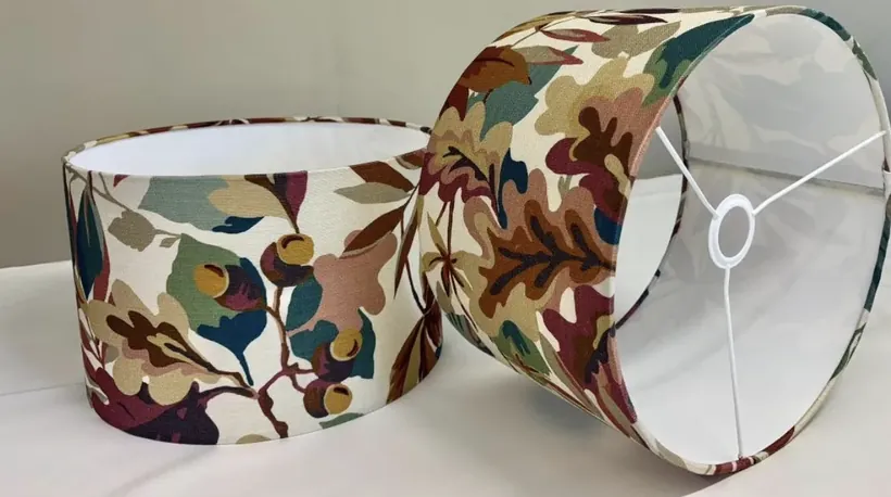Two handmade Sanderson drum lampshades in a warm russet floral