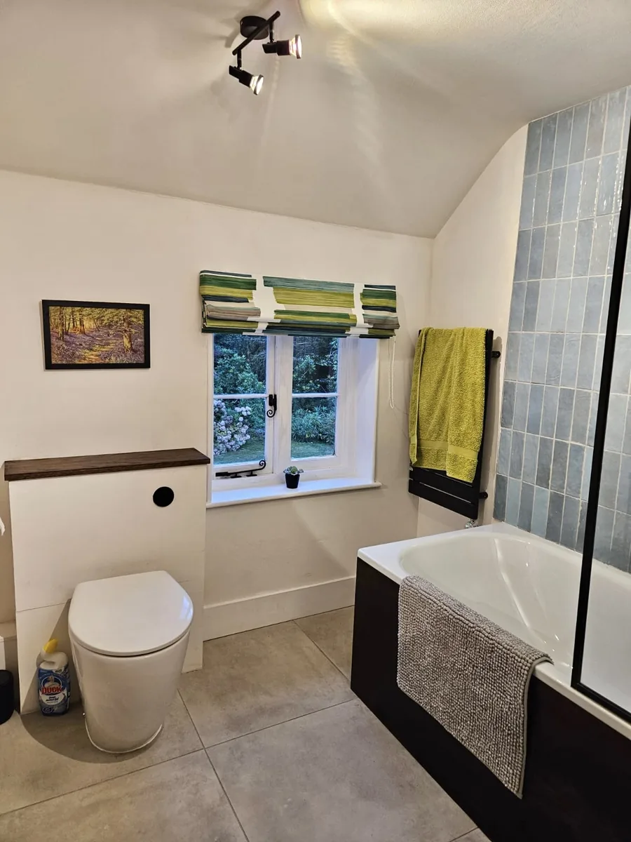 A neat made-to-measure Roman blind in a cottage bathroom