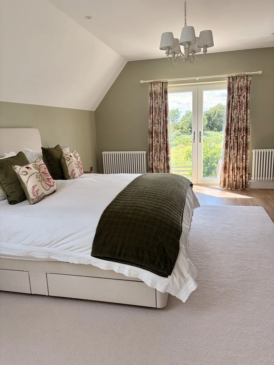 Curtains framing a bedroom window that looks onto the garden